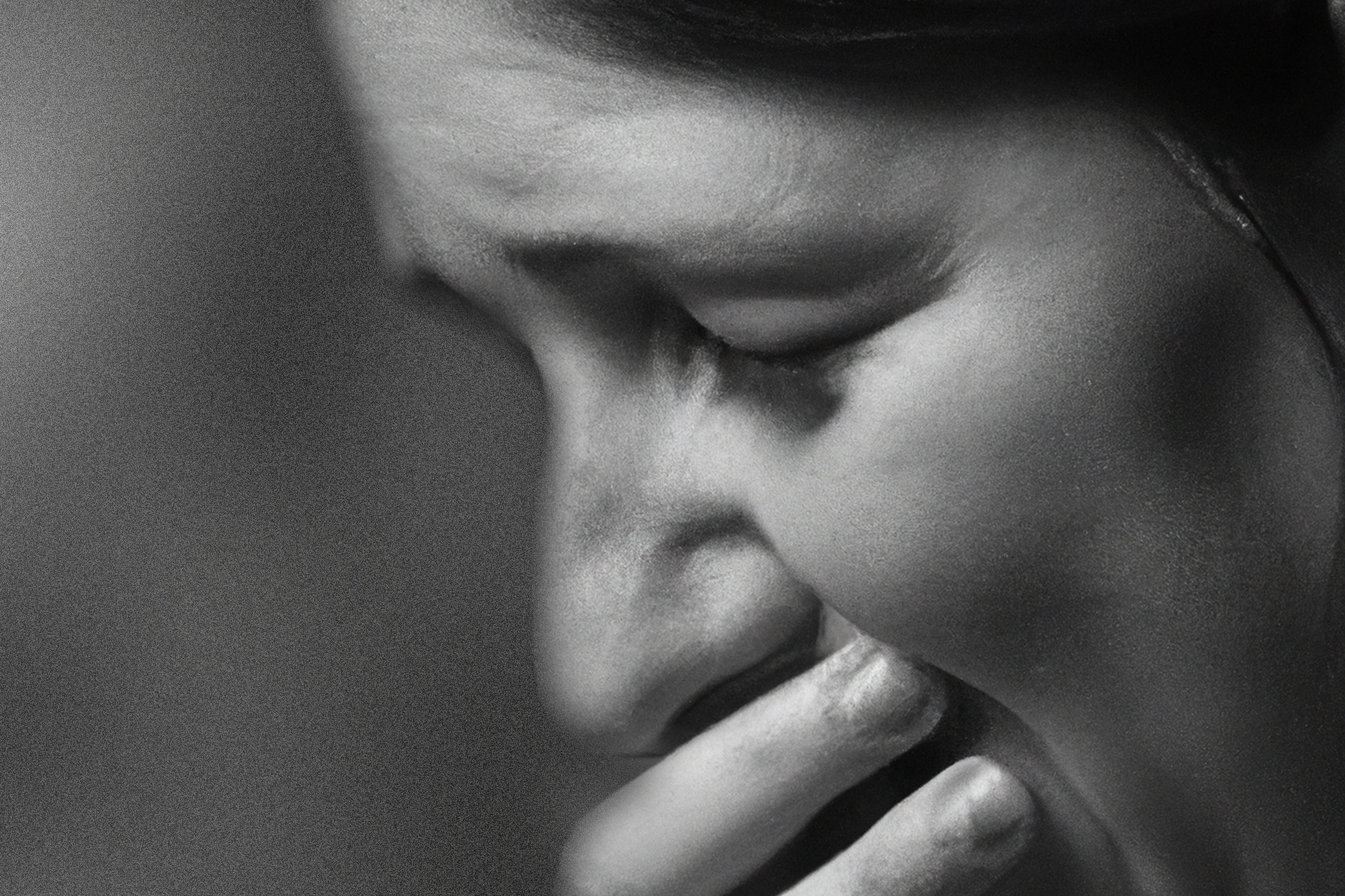 Black white photograph of a woman crying.